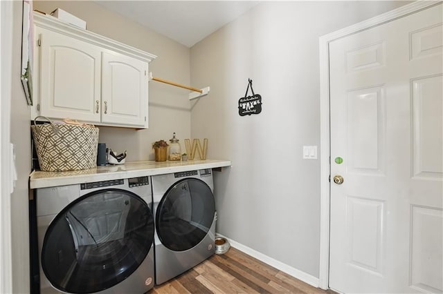 1040 Silverleaf Ln, Liberty, MO 64068 - laundry room with cabinet space, independent washer and dryer, baseboards, and light wood-type flooring