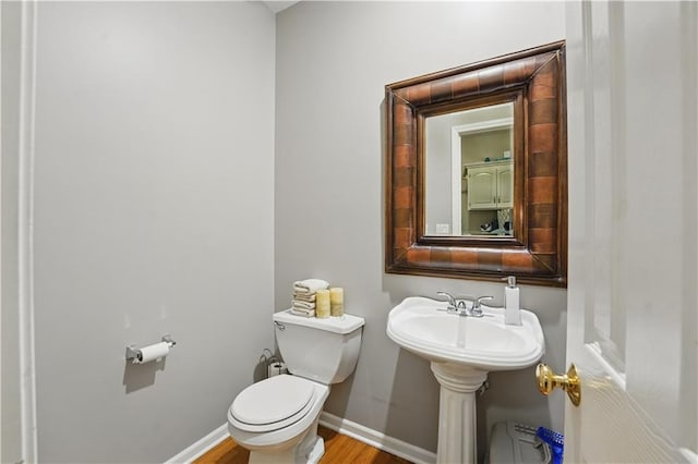 1040 Silverleaf Ln, Liberty, MO 64068 - bathroom with toilet, wood finished floors, and baseboards
