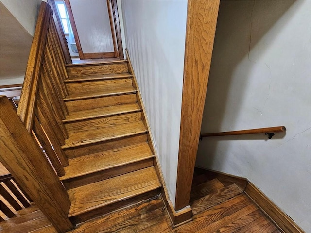 stairs with baseboards and wood finished floors