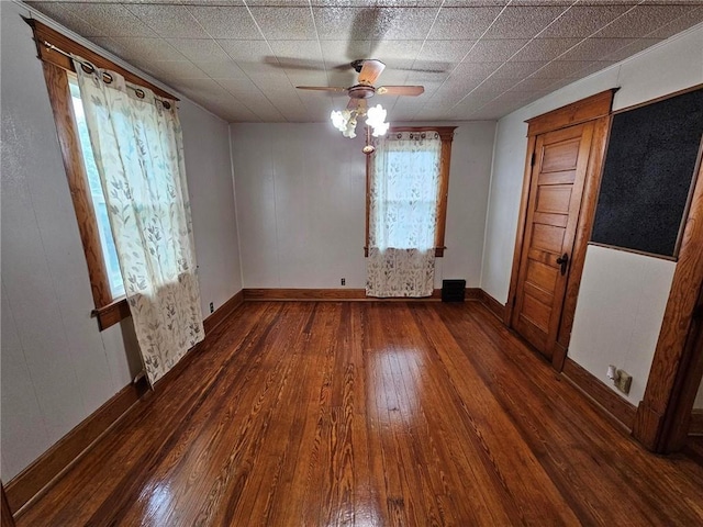 unfurnished room featuring hardwood / wood-style floors, a ceiling fan, and baseboards