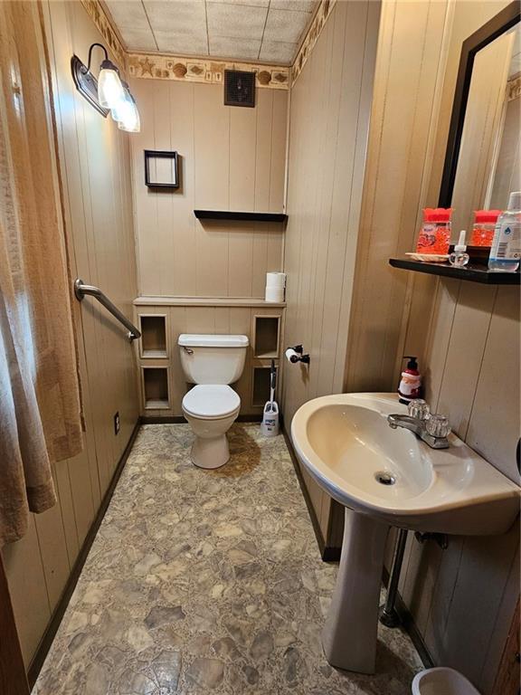half bath with toilet and a sink