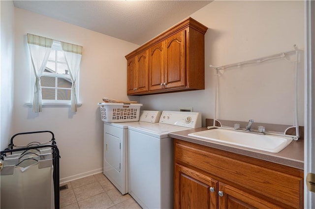 3100 Clarendon Rd, Sedalia, MO 65301 - washroom featuring washer and dryer, cabinet space, baseboards, and light tile patterned floors