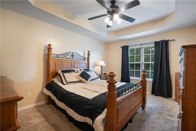 3100 Clarendon Rd, Sedalia, MO 65301 - bedroom featuring light colored carpet, a raised ceiling, baseboards, and a ceiling fan