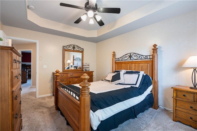 3100 Clarendon Rd, Sedalia, MO 65301 - bedroom featuring light colored carpet, a raised ceiling, a ceiling fan, and baseboards