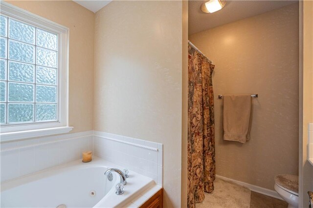 3100 Clarendon Rd, Sedalia, MO 65301 - full bath with toilet, a tub with jets, a shower with shower curtain, and baseboards