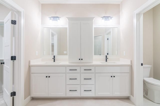 16729 Pinehurst Dr, Basehor, KS 66007 - bathroom with toilet, double vanity, and baseboards