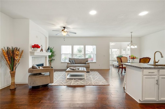23713 W 88th St, Lenexa, KS 66227 - living area featuring recessed lighting, dark wood-style floors, ceiling fan, a fireplace, and baseboards