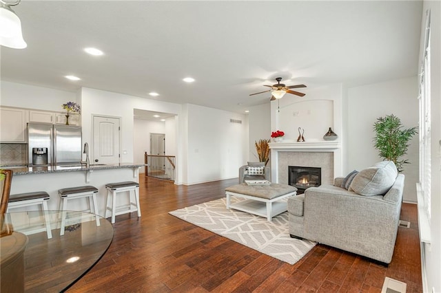 23713 W 88th St, Lenexa, KS 66227 - living area with recessed lighting, dark wood finished floors, a ceiling fan, and a fireplace