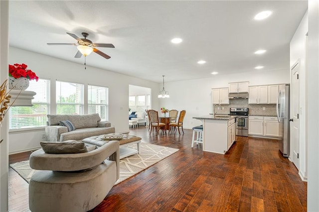 23713 W 88th St, Lenexa, KS 66227 - living area with ceiling fan, healthy amount of natural light, dark wood finished floors, and recessed lighting
