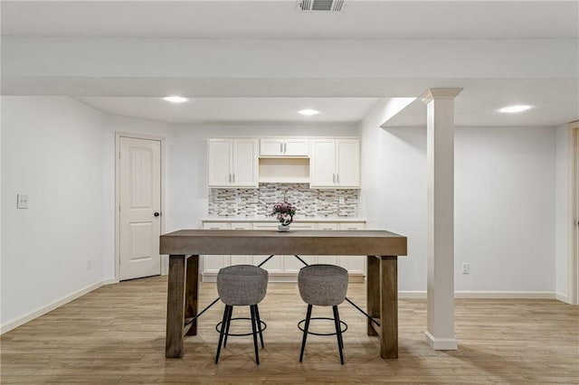 23713 W 88th St, Lenexa, KS 66227 - kitchen featuring light wood-style flooring, tasteful backsplash, baseboards, white cabinetry, and recessed lighting