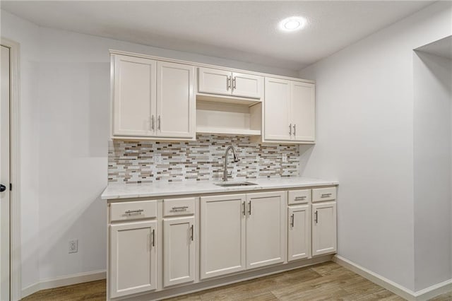 23713 W 88th St, Lenexa, KS 66227 - kitchen featuring a sink, backsplash, light wood-type flooring, light countertops, and recessed lighting