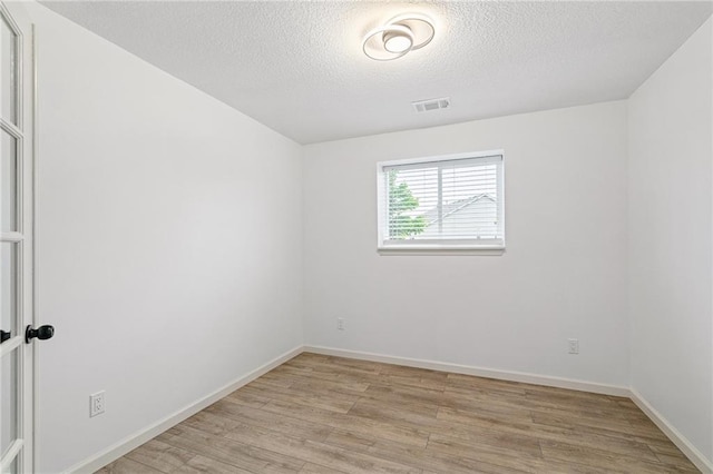 23713 W 88th St, Lenexa, KS 66227 - unfurnished room with light wood finished floors, a textured ceiling, and baseboards