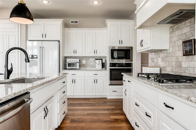 15670 W 165th Ter, Olathe, KS 66062 - kitchen with appliances with stainless steel finishes, a sink, premium range hood, tasteful backsplash, and white cabinetry