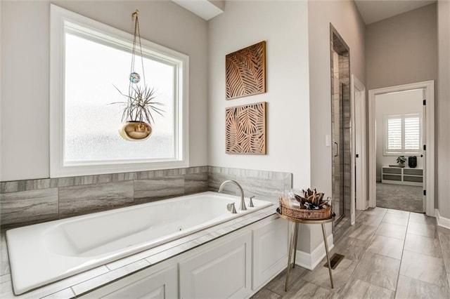 15670 W 165th Ter, Olathe, KS 66062 - full bathroom featuring a whirlpool tub, a stall shower, and baseboards