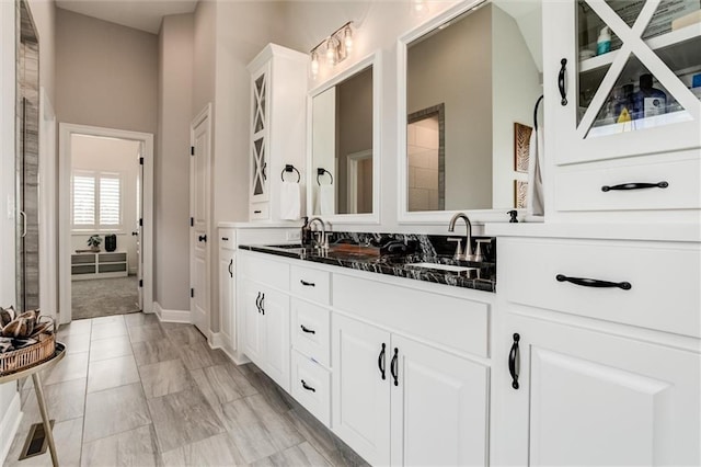 15670 W 165th Ter, Olathe, KS 66062 - full bathroom featuring double vanity, baseboards, and a towering ceiling