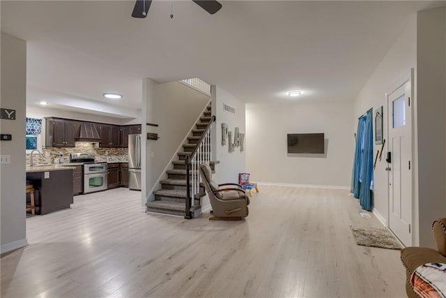21830 S Race St, Spring Hill, KS 66083 - living area featuring light wood-type flooring, stairs, a ceiling fan, and baseboards
