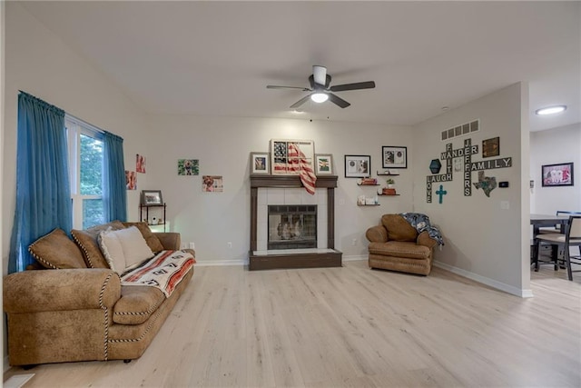 21830 S Race St, Spring Hill, KS 66083 - living area featuring light wood-style flooring, ceiling fan, a tile fireplace, and baseboards