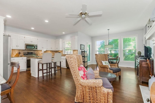 11304 W 144th St, Overland Park, KS 66221 - living room featuring dark wood finished floors, a ceiling fan, recessed lighting, and baseboards