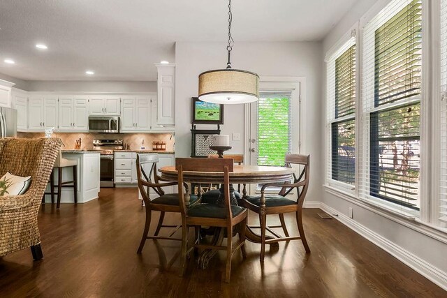 11304 W 144th St, Overland Park, KS 66221 - dining space featuring dark wood finished floors, baseboards, and recessed lighting