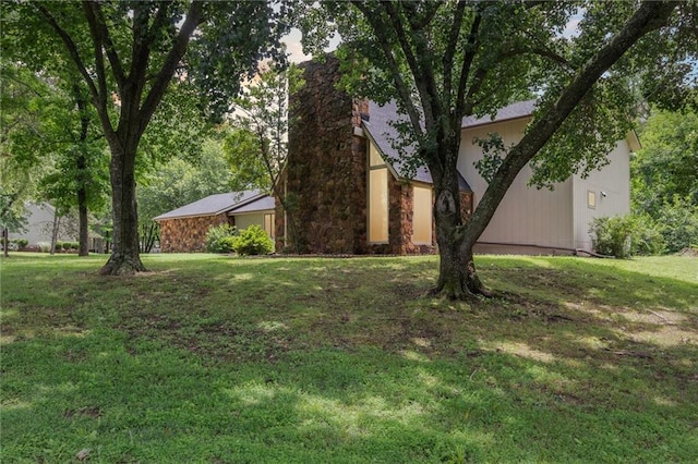 501 Taylor Rd, Independence, KS 67301 - view of front of property featuring a front lawn, stone siding, and a chimney