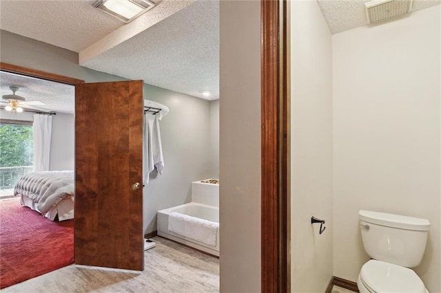 501 Taylor Rd, Independence, KS 67301 - full bathroom featuring a textured ceiling, a bath, connected bathroom, and a ceiling fan