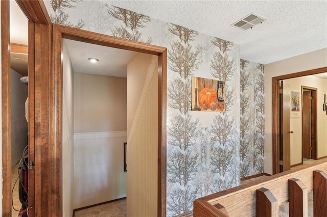 501 Taylor Rd, Independence, KS 67301 - hallway featuring a textured ceiling and wallpapered walls
