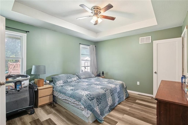 1022 N Davis Rd, Ottawa, KS 66067 - bedroom with a raised ceiling, wood finished floors, and ceiling fan