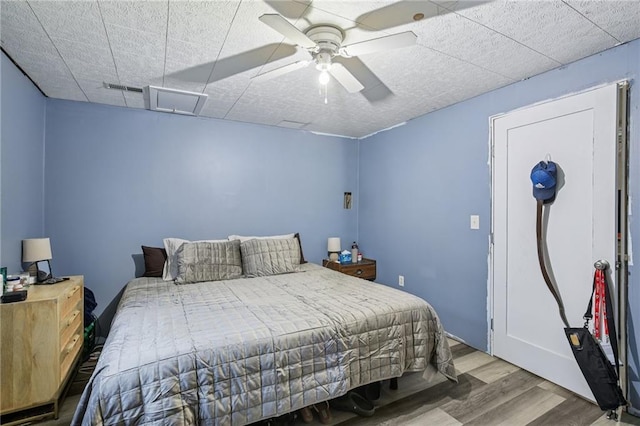 1022 N Davis Rd, Ottawa, KS 66067 - bedroom featuring wood finished floors, a drop ceiling, and a ceiling fan