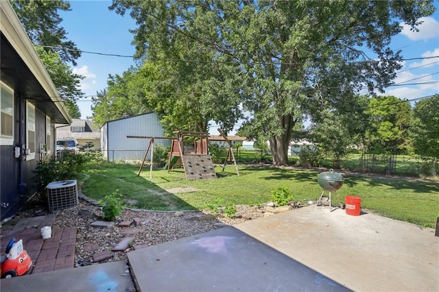 1022 N Davis Rd, Ottawa, KS 66067 - fenced backyard featuring a playground and a patio