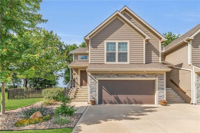 1302 N 159th St, Basehor, KS 66007 - view of front of property featuring stairway, an attached garage, driveway, a shingled roof, and stone siding