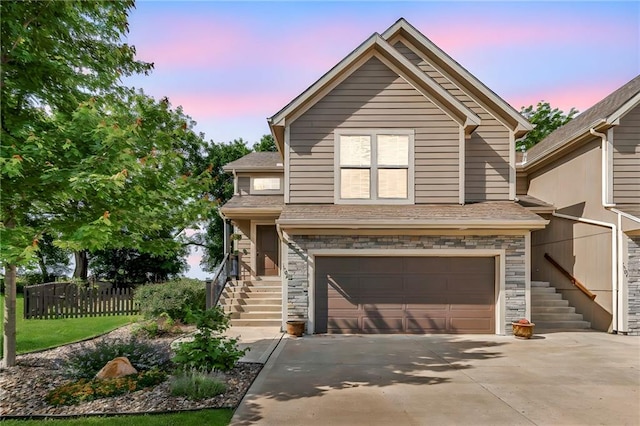 1302 N 159th St, Basehor, KS 66007 - traditional-style home with stairway, a garage, stone siding, and concrete driveway