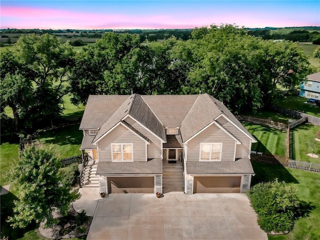 1302 N 159th St, Basehor, KS 66007 - view of front facade with an attached garage, concrete driveway, stone siding, roof with shingles, and stairway