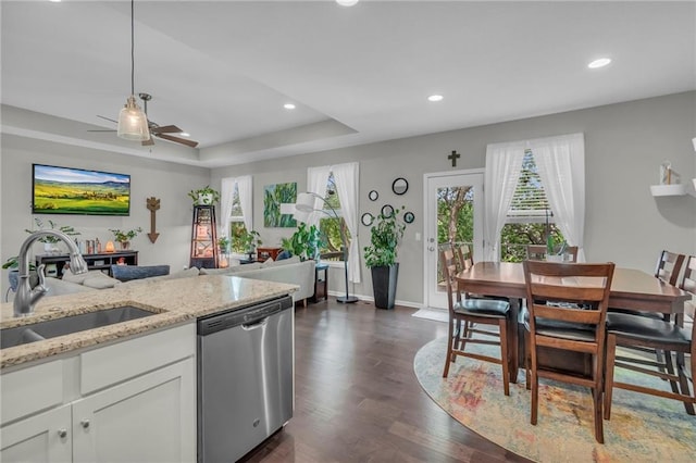 1302 N 159th St, Basehor, KS 66007 - kitchen featuring stainless steel dishwasher, a sink, ceiling fan, dark wood-type flooring, and white cabinets