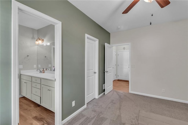 1302 N 159th St, Basehor, KS 66007 - bedroom with baseboards, ensuite bath, a sink, and light carpet