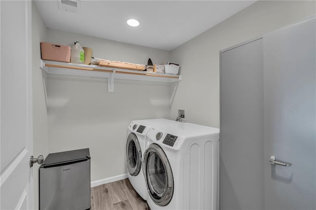 1302 N 159th St, Basehor, KS 66007 - washroom featuring separate washer and dryer, light wood-style flooring, and baseboards
