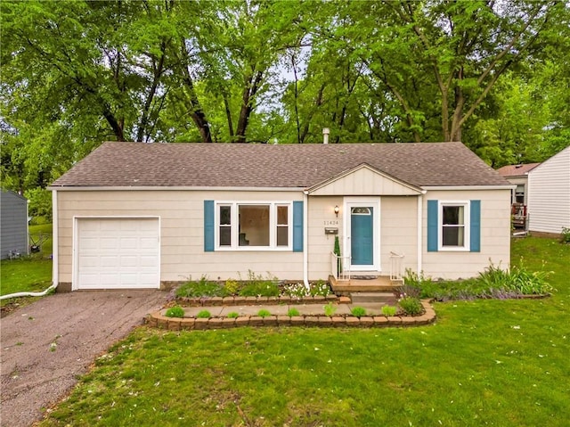 11424 W 67th Ter, Shawnee, KS 66203 - view of front of property with a garage, roof with shingles, a front yard, driveway, and board and batten siding