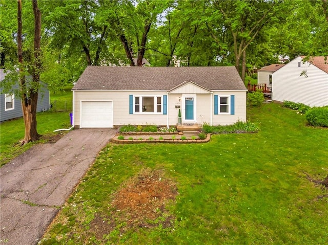 11424 W 67th Ter, Shawnee, KS 66203 - ranch-style house with an attached garage, driveway, a front yard, and roof with shingles