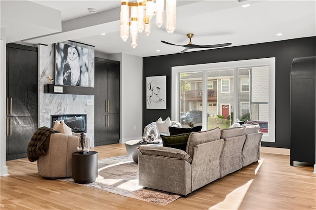 4550 Bell St, Kansas City, MO 64111 - living area featuring light wood-style floors, a ceiling fan, a fireplace, and recessed lighting