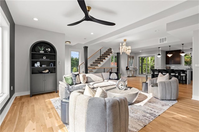 4550 Bell St, Kansas City, MO 64111 - living room featuring stairs, a ceiling fan, light wood-type flooring, recessed lighting, and a chandelier