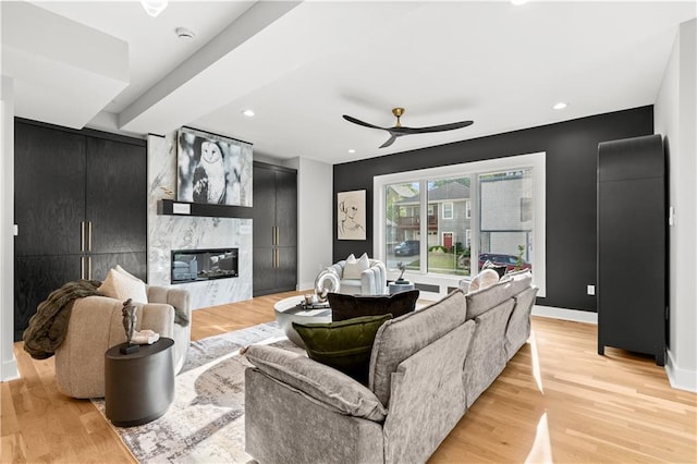 4550 Bell St, Kansas City, MO 64111 - living room featuring a ceiling fan, light wood finished floors, a fireplace, and recessed lighting