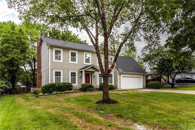 10404 Flint St, Overland Park, KS 66214 - colonial-style house with a garage, driveway, and a chimney