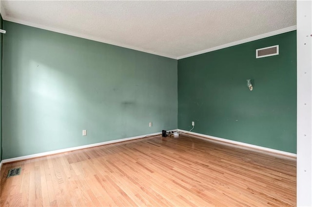 10404 Flint St, Overland Park, KS 66214 - spare room featuring ornamental molding, wood finished floors, a textured ceiling, and baseboards