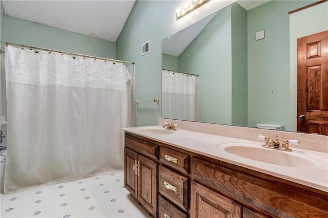 10404 Flint St, Overland Park, KS 66214 - full bath featuring double vanity, tile patterned floors, lofted ceiling, curtained shower, and toilet