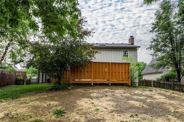 10404 Flint St, Overland Park, KS 66214 - rear view of property with a chimney, a fenced backyard, and a wooden deck