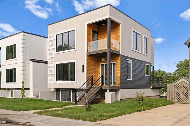 4544 Bell St, Kansas City, MO 64111 - modern home with a balcony, a front lawn, stucco siding, and a standing seam roof