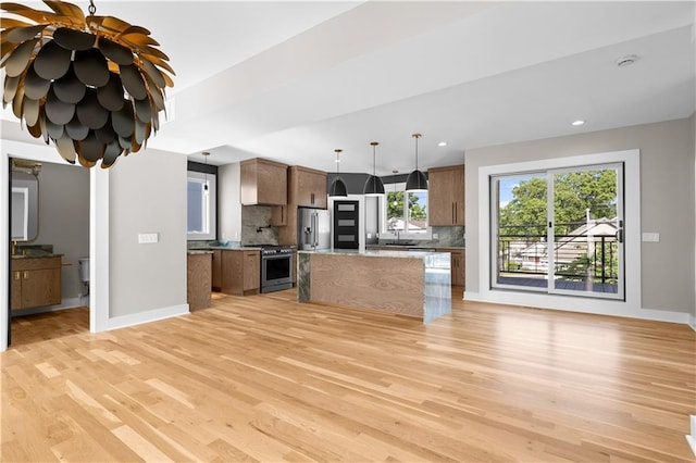 4544 Bell St, Kansas City, MO 64111 - kitchen featuring stainless steel appliances, light wood-style flooring, decorative backsplash, and recessed lighting