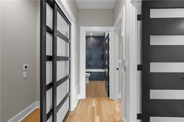 4544 Bell St, Kansas City, MO 64111 - corridor with light wood-style floors and baseboards