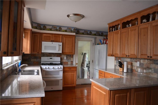 7141 SW F Hwy, Trimble, MO 64492 - kitchen featuring white appliances, a sink, a peninsula, tasteful backsplash, and dark wood finished floors
