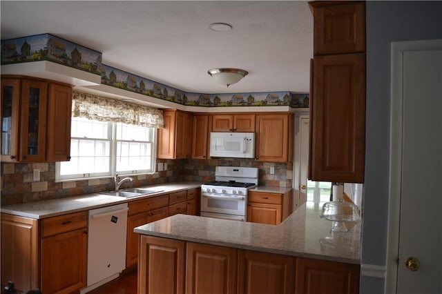 7141 SW F Hwy, Trimble, MO 64492 - kitchen featuring white appliances, a sink, decorative backsplash, and a peninsula