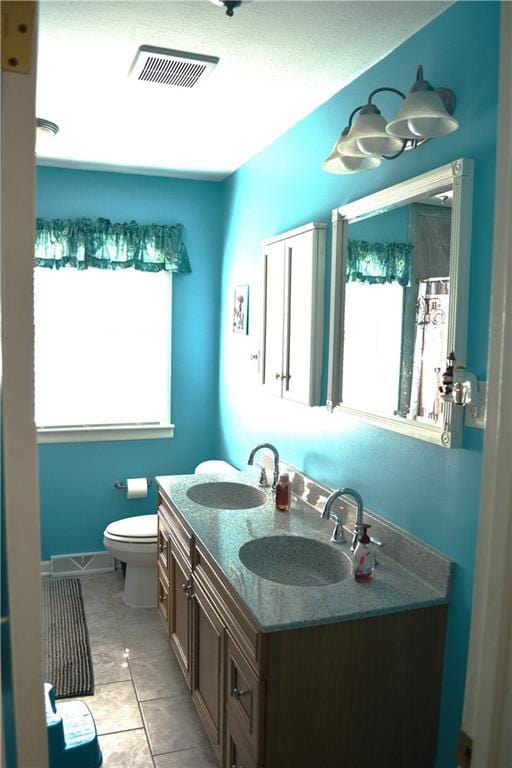 7141 SW F Hwy, Trimble, MO 64492 - full bathroom featuring plenty of natural light, toilet, double vanity, and tile patterned floors